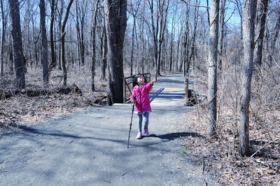 Full length of girl hiking in forest