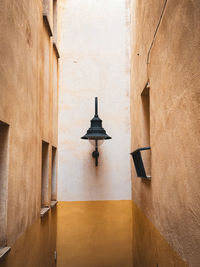 Street lantern on a wall at the end of a narrow isle