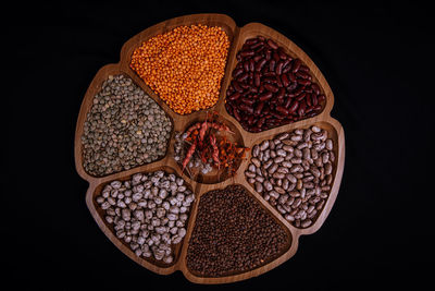 High angle view of candies in bowl against black background