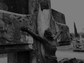 Statue of buddha against wall in old building