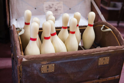 Close-up of bowling pins in container