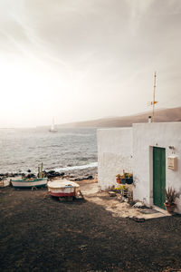 Scenic view of sea against buildings