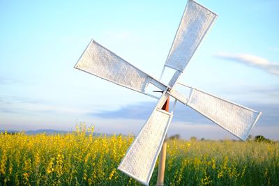 Windmill on field against sky