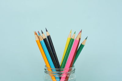 Close-up of colored pencils against white background
