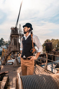 Man standing on boat against sky