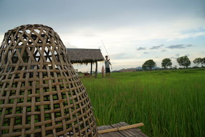 Traditional windmill on field against sky