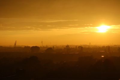 Silhouette of city during sunset