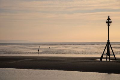 Scenic view of beach against sky during sunset