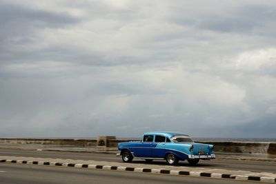 Cars on road against sky
