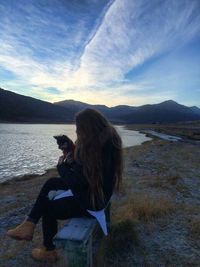 Rear view of people sitting on mountain