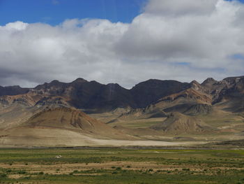 Countryside landscape against mountain range