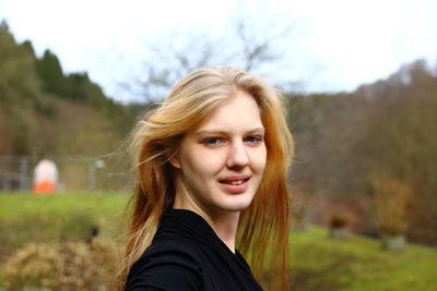 Close-up portrait of smiling young woman