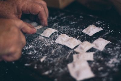 Cropped hand making food