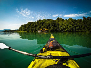 Cropped image of kayak on lake against sky