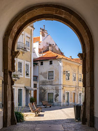 Archway and city gate are passage from cathedral square to republic square in alcobaca, portugal