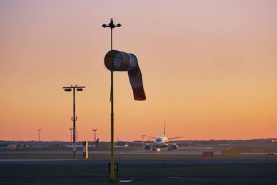 Airplane against sky during sunset