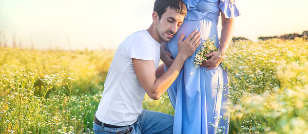 Man touching belly of pregnant woman