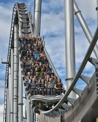 Low angle view of roller coaster ride against the sky