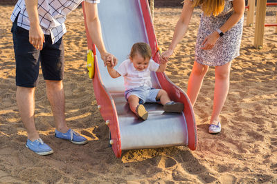 Rear view of children playing on playground