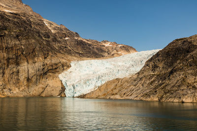 Scenic view of lake and mountains against clear sky