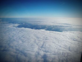 Scenic view of snow landscape against blue sky