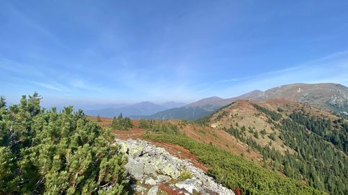 Scenic view of mountains against blue sky