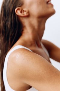 Side view of woman looking away against white background