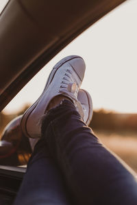 Low section of person resting on car window