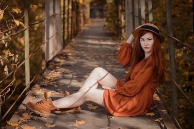 Portrait of young woman sitting in park