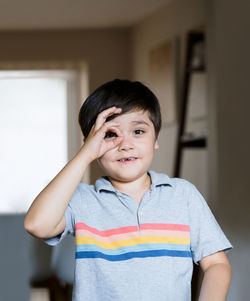 Portrait of boy standing at home