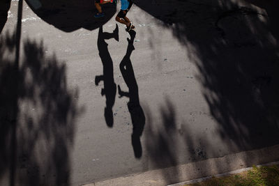 Low section of man walking on wet street