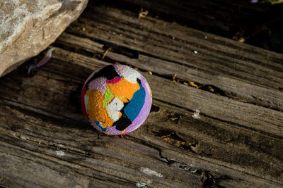 High angle view of multi colored ball on wooden plank