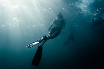 Full length of people swimming under sea