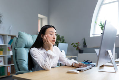 Portrait of young businesswoman working at clinic