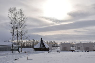 Scenic view of snow covered field against sky during sunset