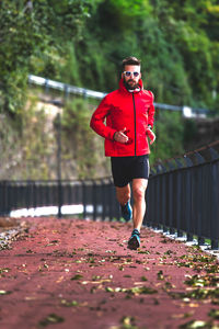 Portrait of man running on street