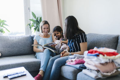 Mothers with daughter on sofa