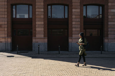 Rear view of man walking on street