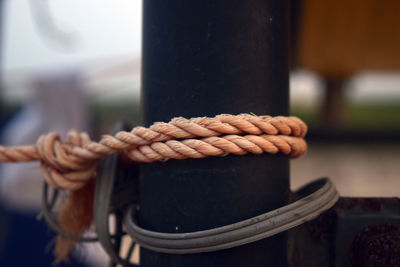 Close-up of rope tied to pole outdoors