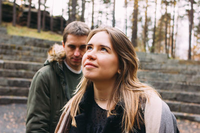 Smiling couple standing in forest