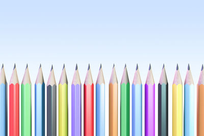 Close-up of colored pencils against white background