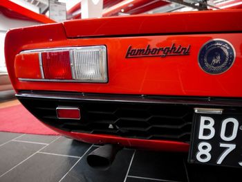 Close-up of red vintage car in city