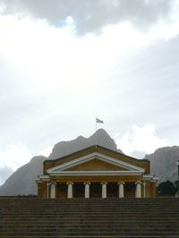 Low angle view of building against cloudy sky