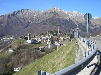 Scenic view of mountains and buildings against sky