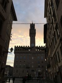 Low angle view of buildings against sky during sunset