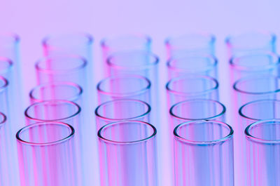 Close-up of test tubes against colored background