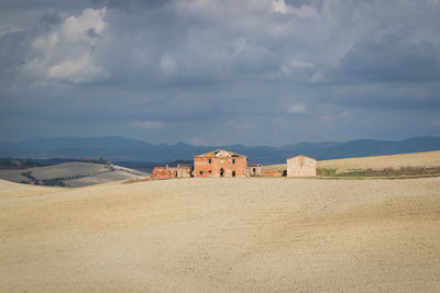 Buildings on mountain against sky