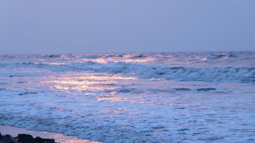 Scenic view of sea against clear sky during sunset