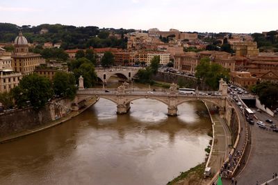High angle view of arch bridge over river in city
