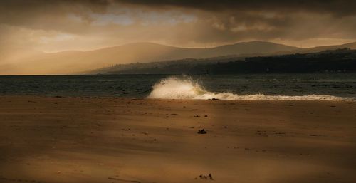 Scenic view of beach against sky during sunset